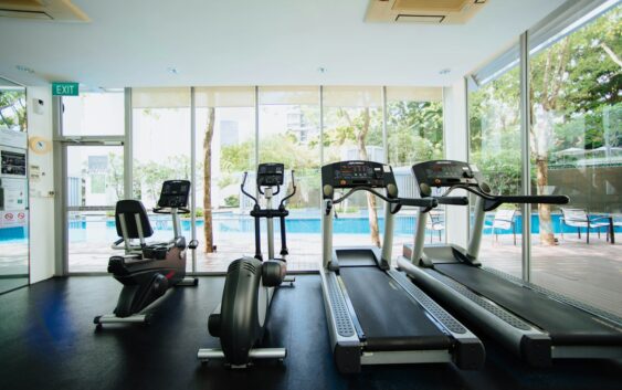 black and grey treadmill and stationary bikes